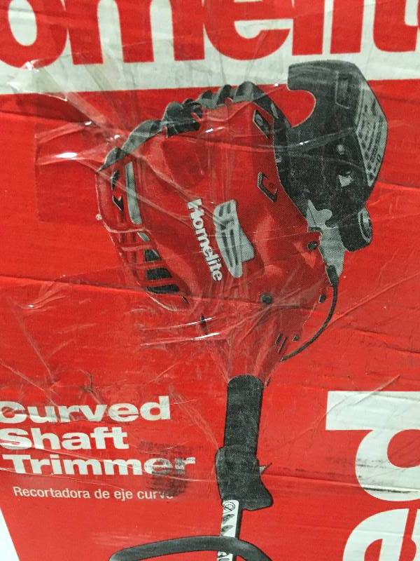 lot 31 image: Homelite 2-Cycle 26 cc Curved Shaft Gas Trimmer in working conditions