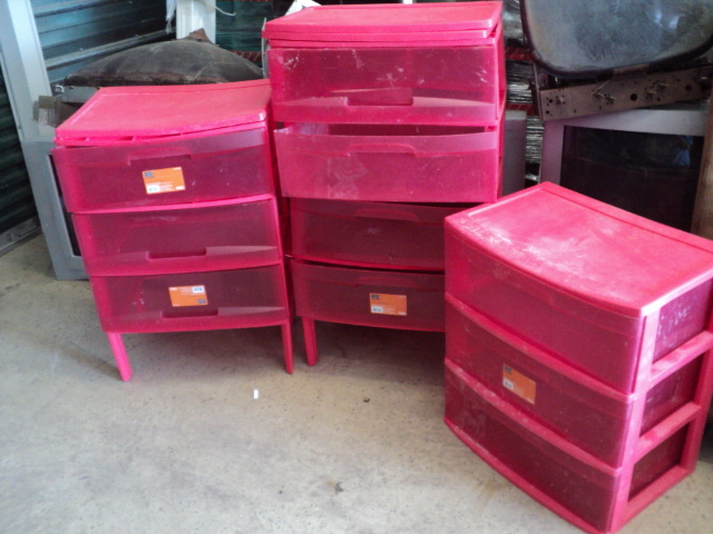 3 red plastic storage units...