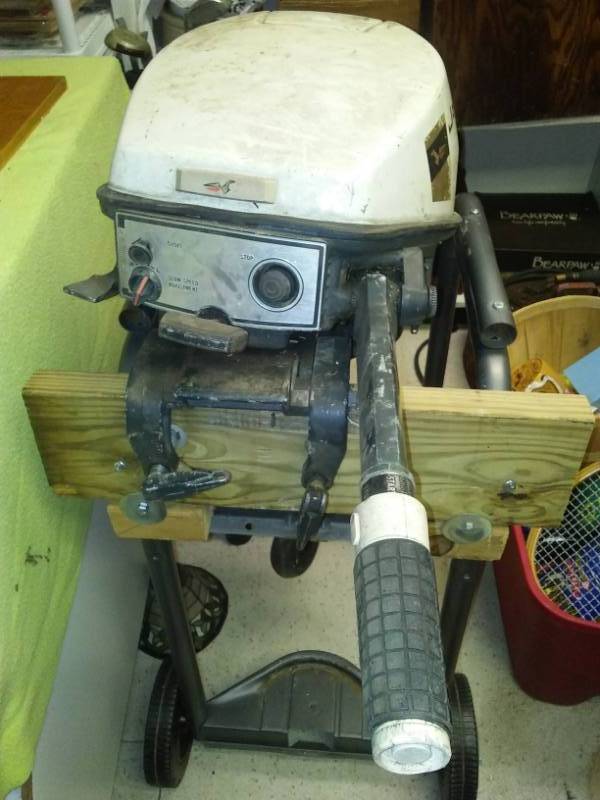 lot 60 image: Johnson 9.5 hp outboard motor and two tanks.