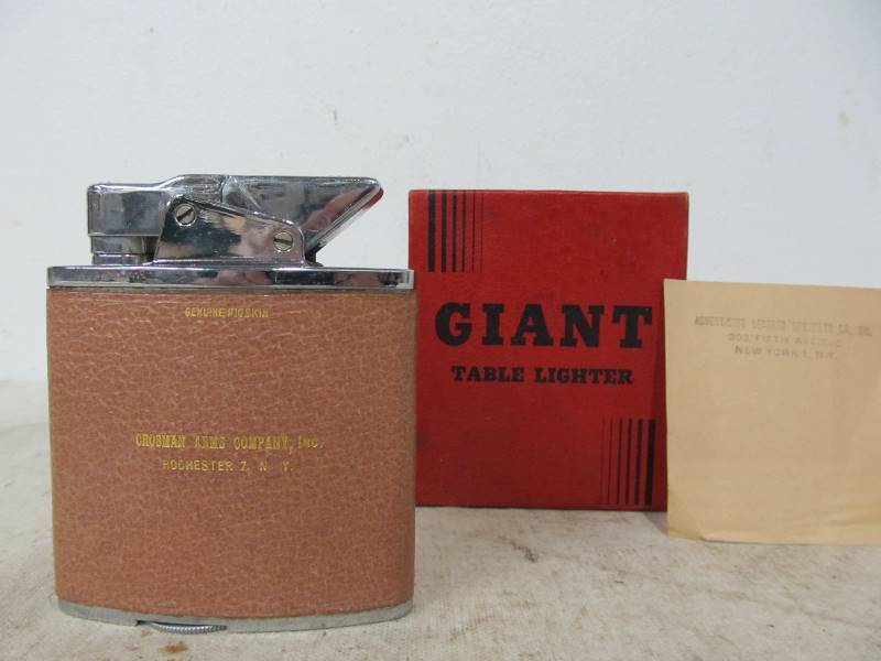 lot 37 image: Vintage CROSMAN ARMS COMPANY Advertising Table Lighter