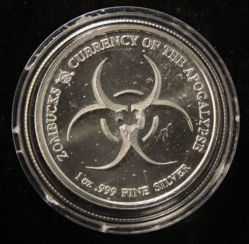 lot 62 image: 1 TROY OZ. .999 FINE SILVER ZOMBUCKS 2019 SAINT IN AIRTITE