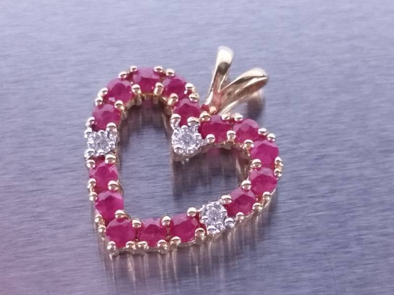 lot 59 image: Ruby and Diamond Pendant in Yellow Gold