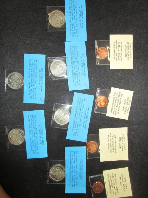 lot 4 image: 6 2000 Liberian $10 Coins and 4 14 oz Copper Medallions