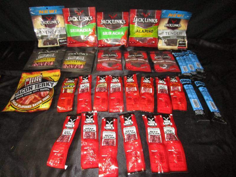 lot 60 image: Total 0f 30  Peppered, Siracha, Jalapeno, Teriyaki, Hickory Smoked bags of beef jerky. Plus peppered, garlic, sweet&hot jerky sticks