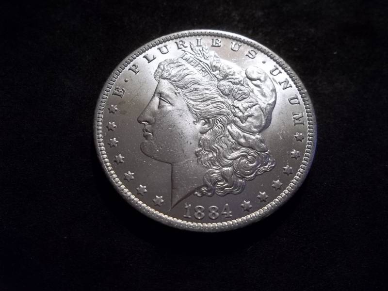 lot 13 image: 1884 O Morgan Silver Dollar