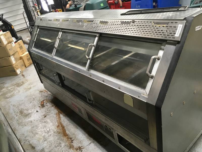 lot 1 image: Custom Delis Stainless steel Hot Food Display and Steam Table Used with in last 5 month, there is some tear and wear from use. item is on ground please note winning bidder will need to bring help to remove equipment as is on the ground.