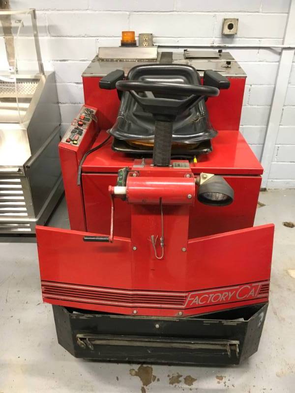 lot 4 image: Factory Cat Model 40 Rider Floor Scrubber used with in the last 5 month. there some tear and wear from use or could be missing parts. PLEASE NOTE WINNING BIDDER WILL NEED TO BRING HELP TO REMOVE ITEM