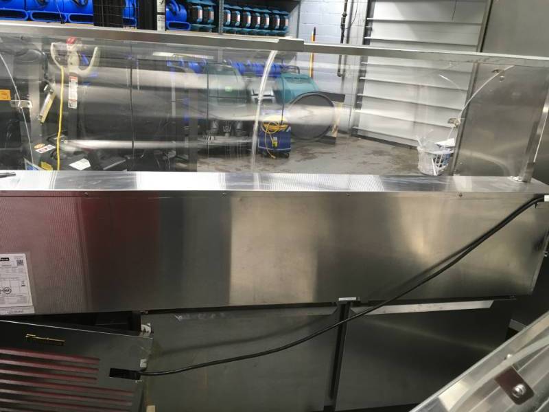 lot 5 image: Traulsen  TD078HT-1 Stainless steel Refrigirator used with in the last 5 month please note winning buyer must bring help to remove item equipment is on the ground. Tear and wear from use or it could have some missing parts.