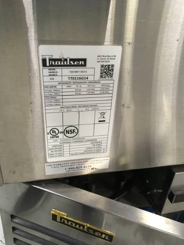 lot 6 image: Traulsen  TD078HT-1 Stainless steel Refrigirator used with in the last 5 month please note winning buyer must bring help to remove item equipment is on the ground. Tear and wear from use or it could have some missing parts.