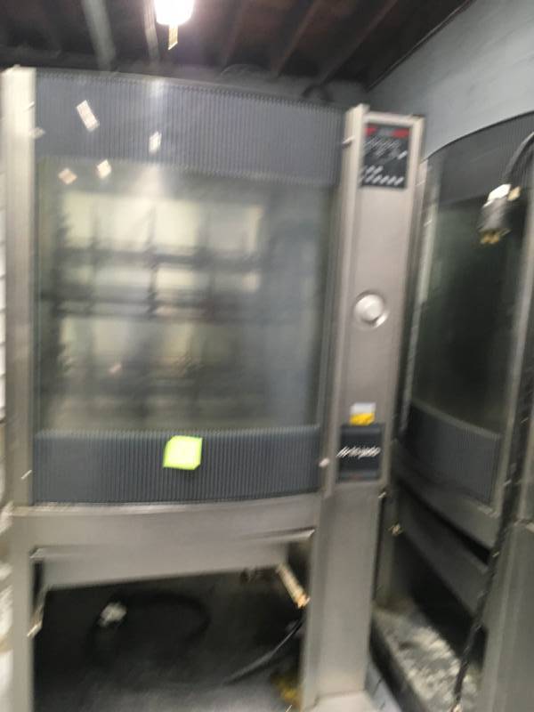 lot 7 image: Fri-Jado STG7-P Stainless steel Single Electric Rotisserie Chicken Meat Baking Pass-Thru Oven used win 5 month inside racks are dirty some dents. Please not winning bidder will need to bring help to remove equipment. Some tear and wear from use.