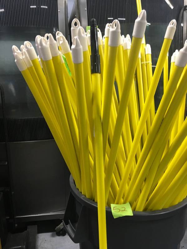 lot 52 image: A bucket of Assorte Broom Sticks.