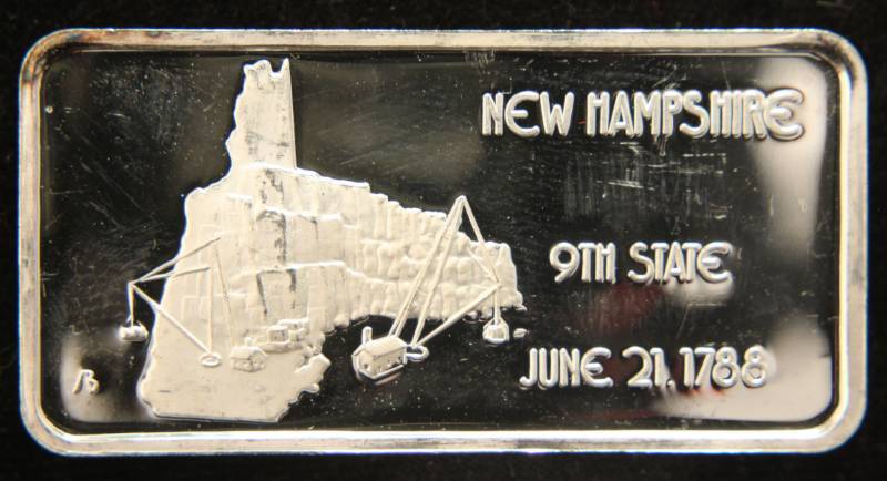 lot 24 image: 1 TROY OZ. .999 FINE SILVER BAR 50 STATES SERIES NEW HAMPSHIRE (NICELY TONED)