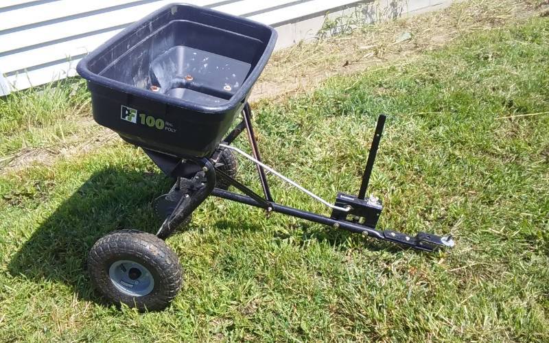 lot 9 image: Precise-Fit 100 LB Pull Behind Broadcast Spreader