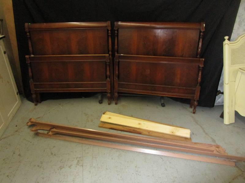 lot 39 image: Two twin Walnut headboards, footboards and frames