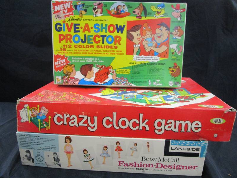 lot 112 image: Betst Mcalls Fashion Designer, Crazy Clock Game and Give A Show Projector all nice in their boxes