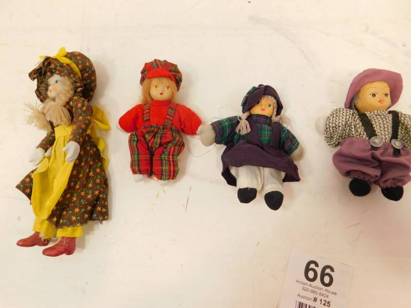 lot 66 image: Four Small Dolls
