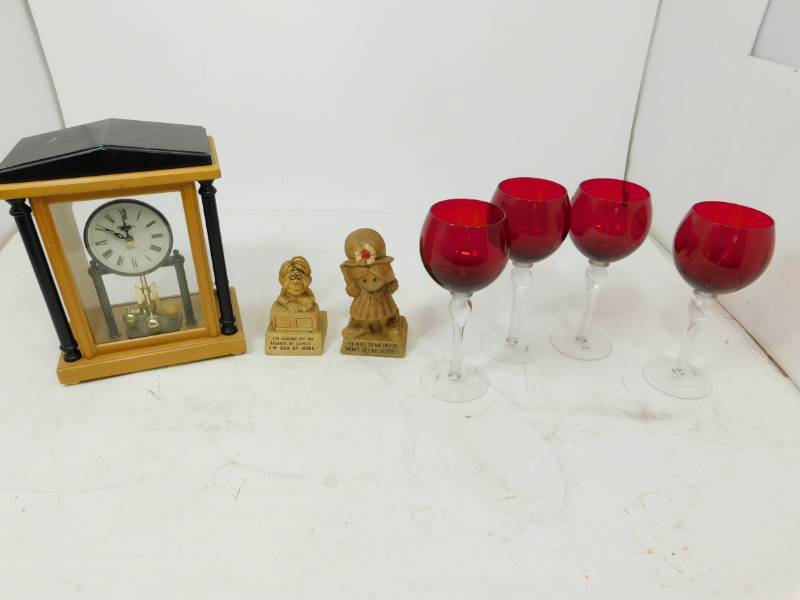 lot 110 image: Bulova Quartz Battery Operated Clock--Four Red & Clear Glass Wine Glasses---Two Small Statues