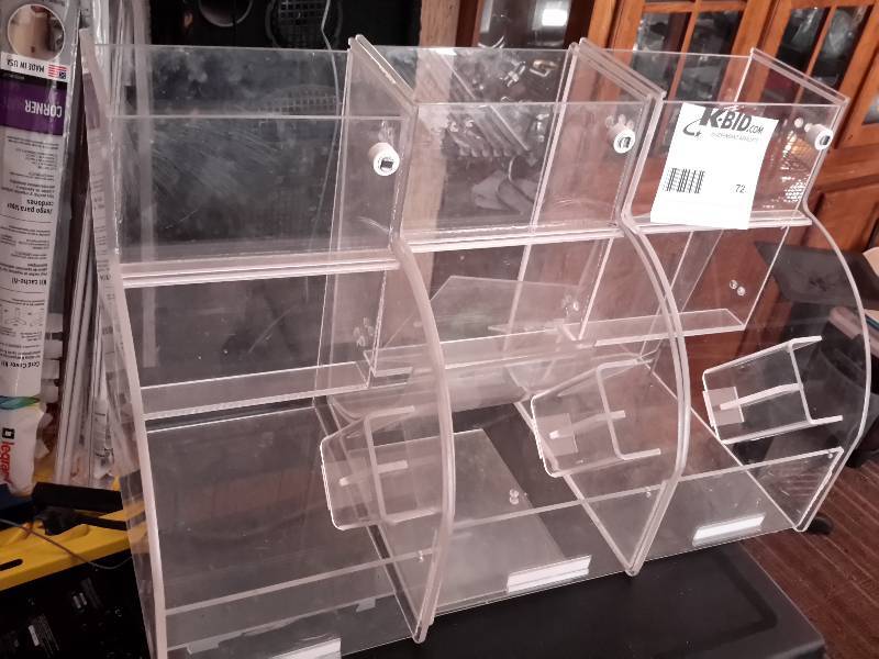 lot 72 image: Acrylic product container with flip top.