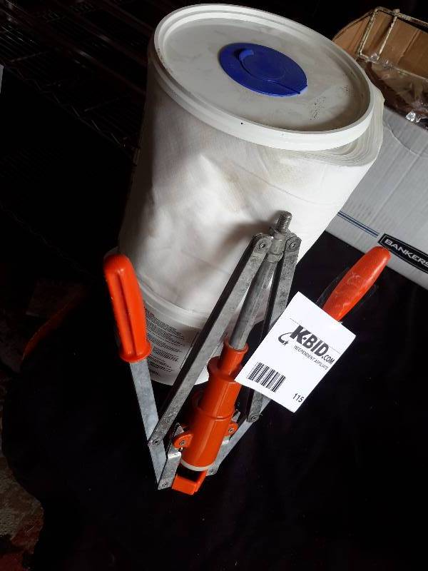 lot 115 image: Manual Bottle capper and a roll of wet wipes and pail