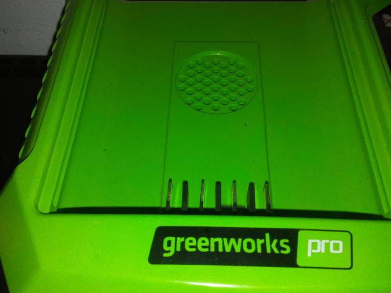 lot 20 image: Greenworks 80 volt charger for mower.