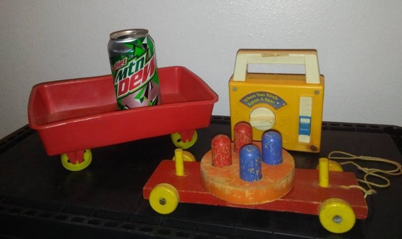 lot 80 image: Fisher-Price radio, Gerber wagon, wood pull toy.