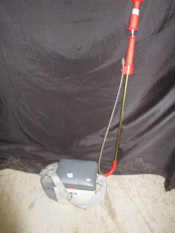 lot 32 image: Rubbermaid Electric Travel Cooler along with a Ridgid septic tank unclogger
