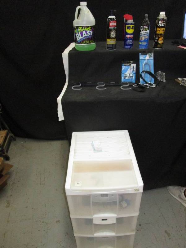 lot 38 image: Plastic Organizer 25 Inches Tall, Full of Misc Tools. Bug Blast, Hornet and Wasp Spray, WD-40, National Guard Blanket