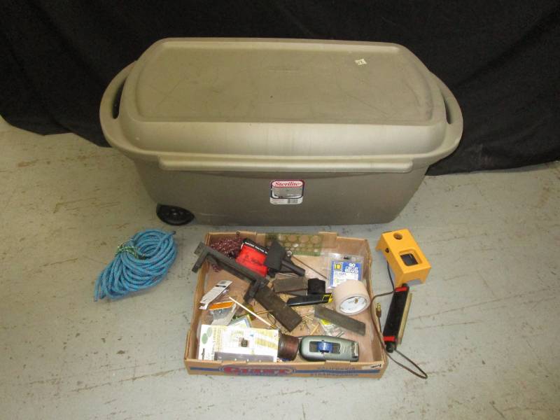 lot 149 image: 44 gal tote on wheels.  Several sharpening hones.