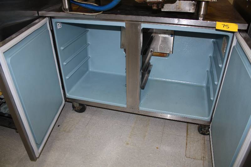 lot 75 image: Delfield, Mod #UC4048, two door under counter refrigerator, NSF, SN 320510-T, caster mounted, 115 volts, 5 amps, 48x28x33H-1 Runs Cools