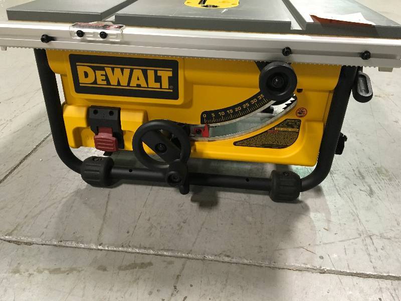 lot 102 image: DEWALT 15 Amp 10 in. Compact Job Site Table Saw missing guide and safety modular guard in like new working condition
