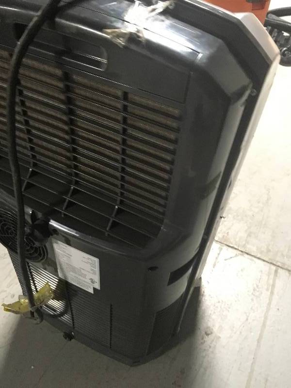 lot 91 image: Whynter 12000 BTU Portable Air Conditioner used missing one wheel and windows exhaust attachments in good working condition