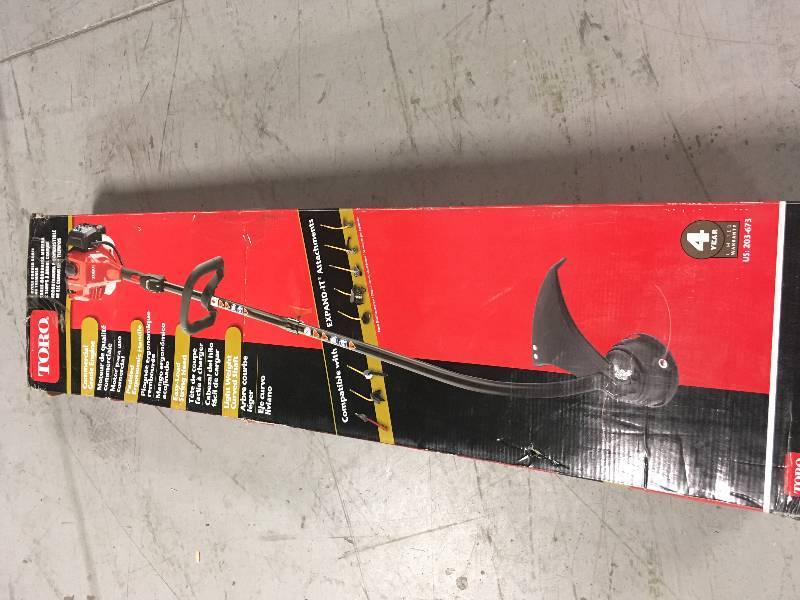lot 98 image: Toro 2-Cycle 25.4cc Attachment Capable Curved Shaft Gas String Trimmer open box in like new condition