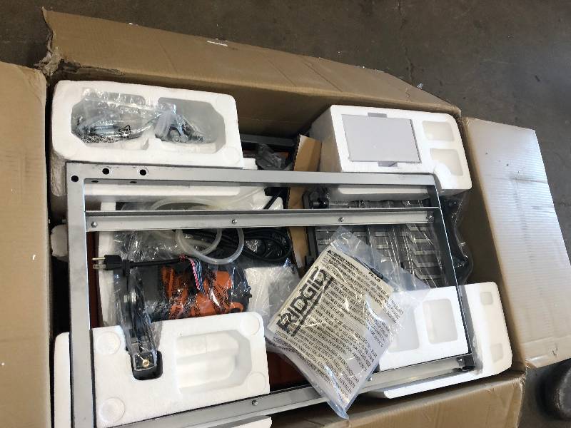 lot 132 image: Ridgid 120-Volt 7 in. Tabletop Wet Tile Saw with Stand in good working conditions not used