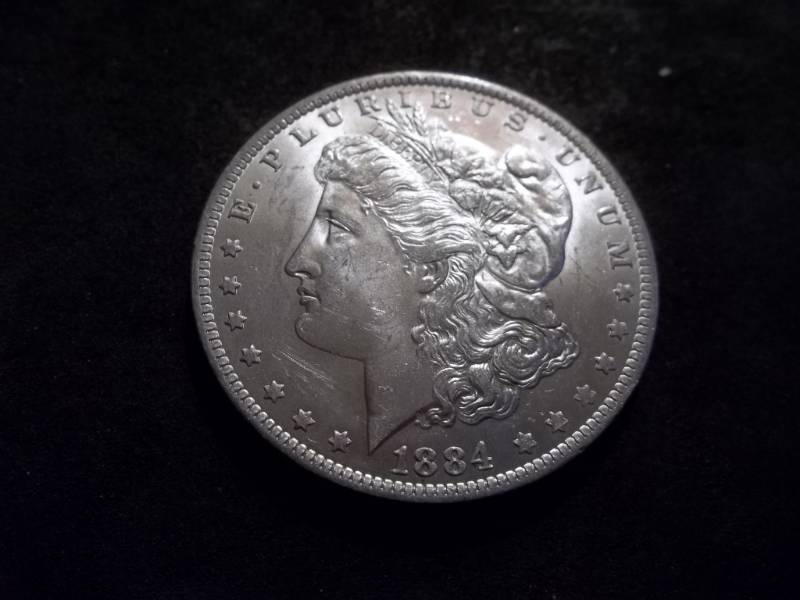 lot 24 image: 1884 O Morgan Silver Dollar