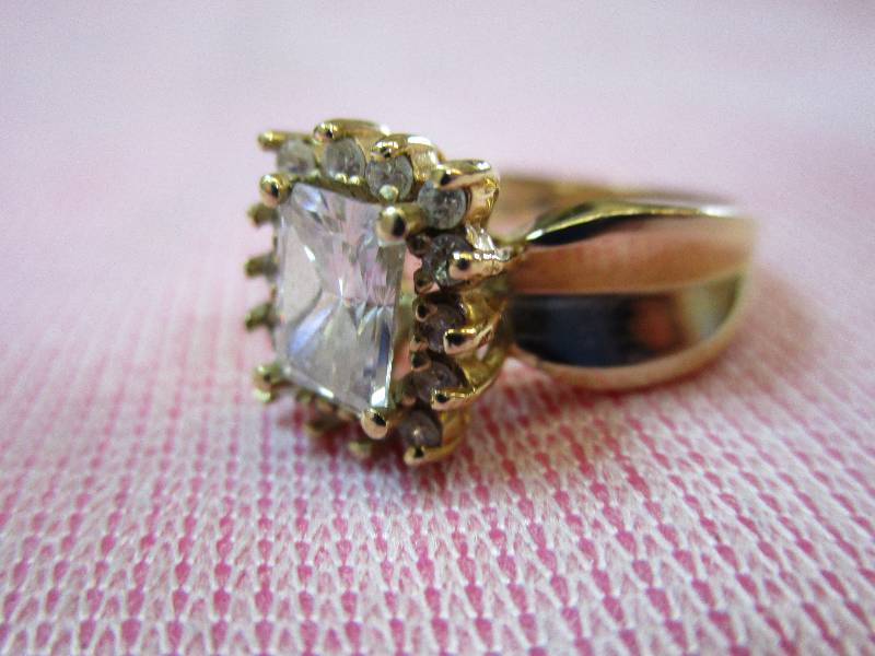 lot 144 image: 14K YELLOW GOLD DIAMONIQUE CZ SIZE 6 PRINCESS HALO RING, 4.4 GRAMS