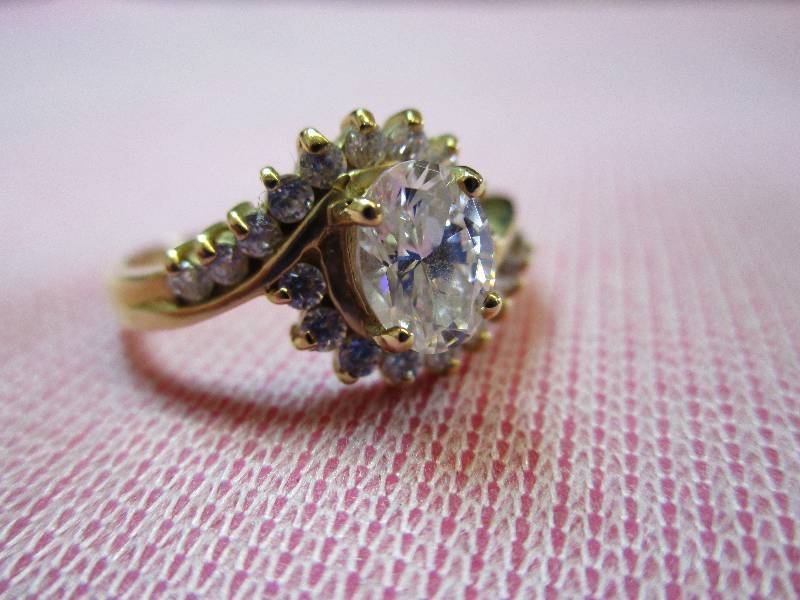 lot 145 image: 14K YELLOW GOLD DIAMONIQUE SIZE 8 OVAL  ROUND CZ RING, 3.5 GRAMS