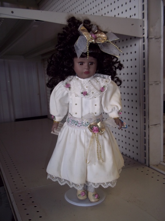 lot 99 image: Collectable Doll with stand