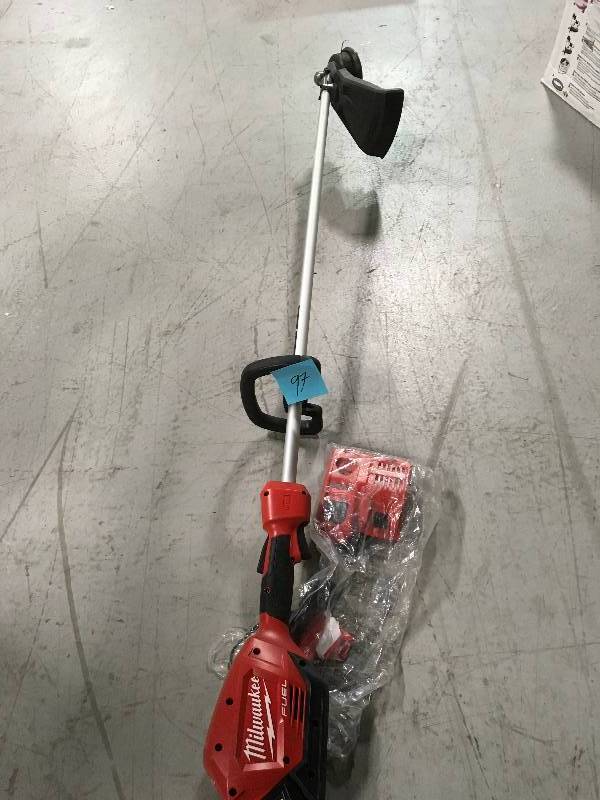 lot 97 image: Milwaukee  M18 string trimmer 1 battery and charger used in working condition