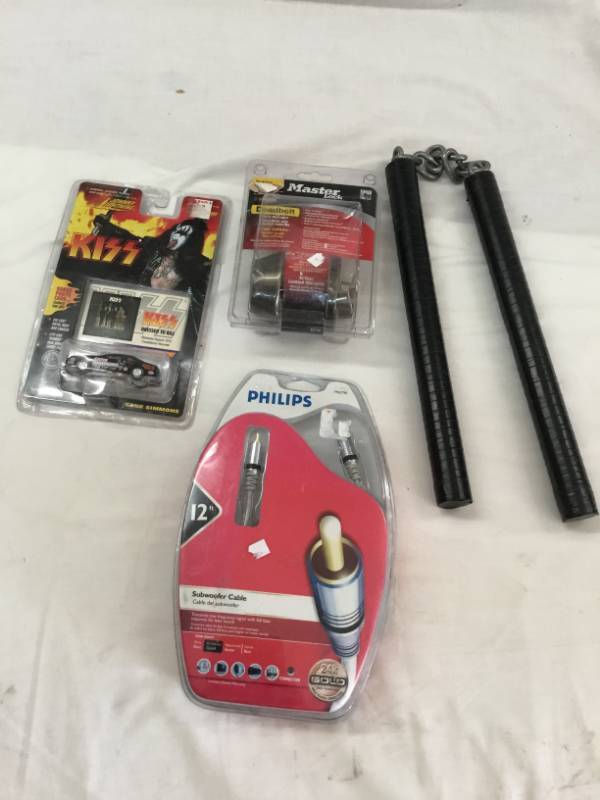 lot 15 image: Decorative Nunchunck, Master Lock Dead Bolt, Gold Tipped Sub woofer cable, Johnny Lightning Kiss Car