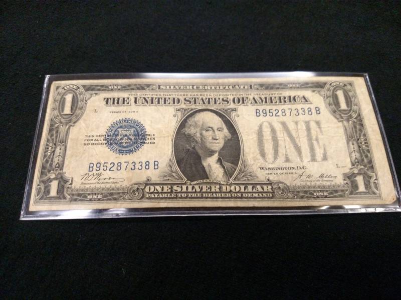 lot 48 image: 1928 A One Dollar Funny Back Silver...