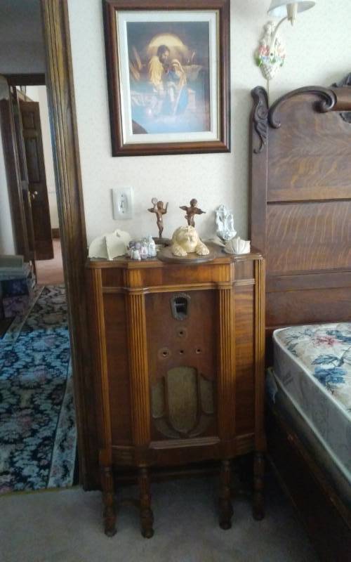 lot 30 image: Old Radio Cabinet Only, Pair Cast Iron Cherub Candle Holders, Misc Religious, Wall Lamp & Picture