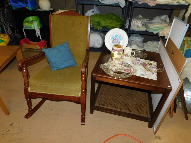 lot 121 image: Medium Brown RockerGreen PillowWooden TableFive Pieces Of Glass Dishes