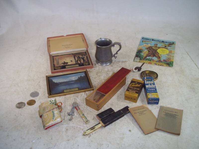 lot 75 image: Comic Book, Silhouette Advertising Pictures, Straight Razor, Pewter mug and bluebooks.