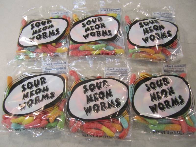 lot 215 image: 6 Bags of Sour Neon Worms Best by F...