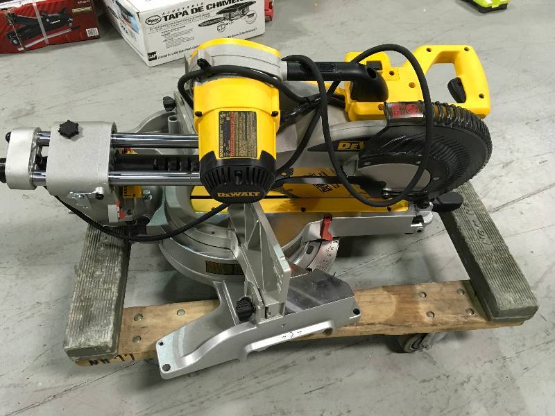 lot 74 image: Dewalt DWS780 12 in. Double Bevel Sliding Compound Miter Saw  Used in good working cond. 4 wheels care are not include tool Only