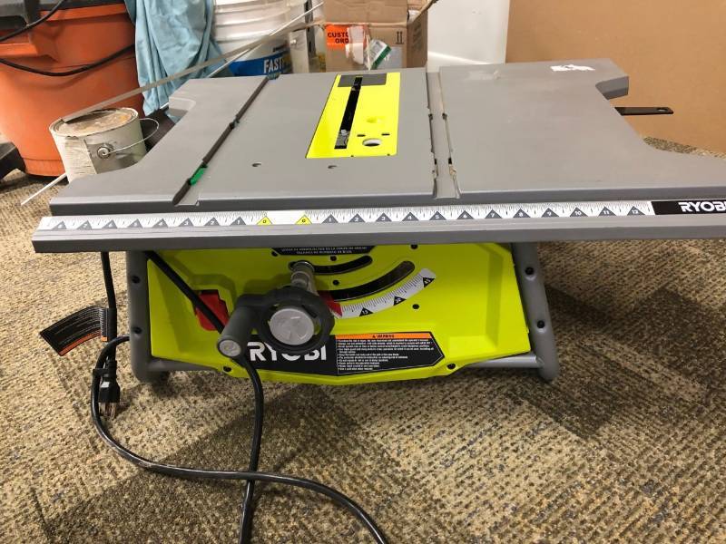 lot 108 image: Ryobi Table saw missing guard and guide used works