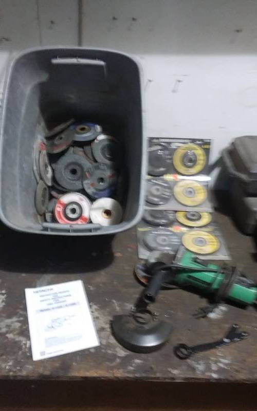 lot 107 image: Hitachi 4 12 In. Angle Grinder With Assorted Grinding Wheels, Cut Off Wheels, Flat Discs, Some New
