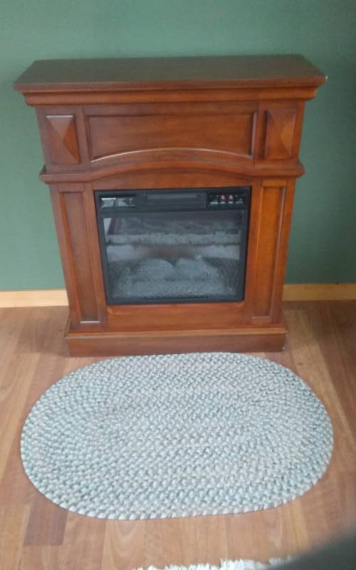 lot 210 image: Electric Fireplace 32x12x36 With Braided Rug