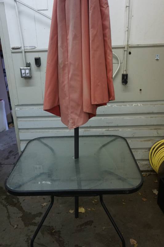 lot 33 image: Glass Top Patio Table With Metal Frame and Umbrella