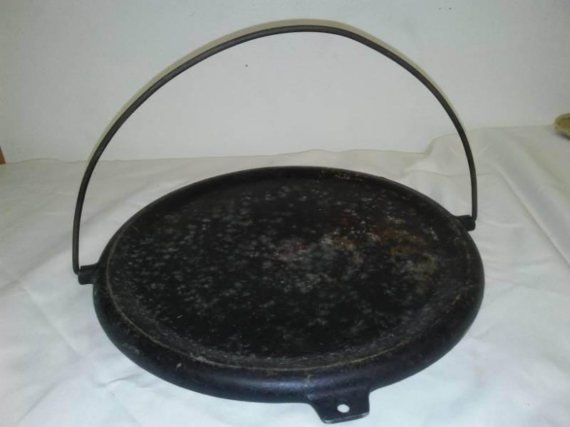 lot 53 image: Cast Iron cover with handle